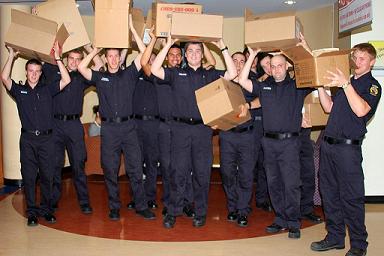 picture of firefighters carrying boxes